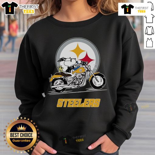 Snoopy and Woodstock in Pittsburgh Steelers sweatshirt riding a motorbike, showcasing team spirit and fun.