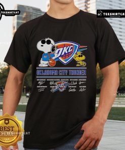 Alt Text: Official Snoopy and Woodstock Oklahoma City Thunder signature t-shirt featuring vibrant graphics and team colors.