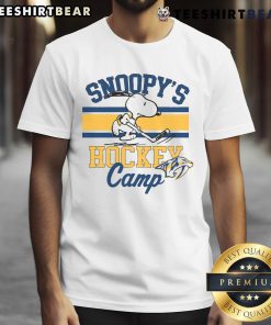 Alt Text: Official Snoopy Nashville Predators T-Shirt from Snoopy's Hockey Camp featuring NHL team logos and vibrant design.