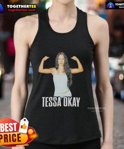 Alt Text: Tessa in a stylish tank top showcasing her muscles and fitness, embodying strength and confidence.