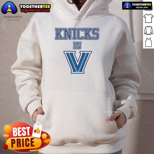 Alt Text: A stylish fan wearing a New York Knicks V hoodie, showcasing team spirit and vibrant colors at a game.