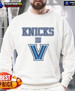 Person wearing a stylish New York Knicks sweatshirt, showcasing team pride in a vibrant urban setting.