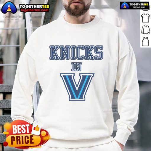 Person wearing a stylish New York Knicks sweatshirt, showcasing team pride in a vibrant urban setting.