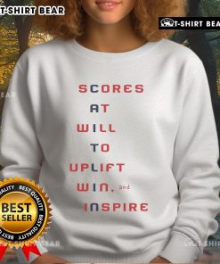 Top Caitlin Clark scores effortlessly in action, wearing a vibrant 'Inspire' sweatshirt during a thrilling game.