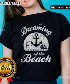 Top featuring 'Dreaming of the Beach' design, perfect for summer happiness, water life, and sand love. Ideal ladies tee.