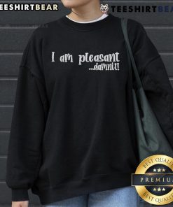 Top I Am Pleasant Damnit Sweatshirt displayed on a wooden table with casual styling, perfect for cozy outfits.