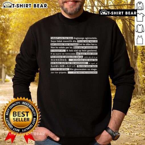 Top I Didn't Vote For Him In Multiple Languages Sweatshirt featuring bold text design for political statement fashion.