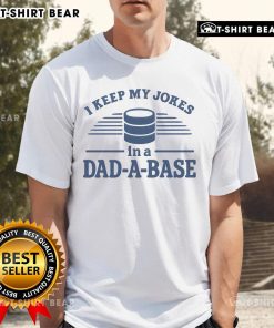 Man wearing a 'Top I Keep My Jokes In A Dad-A-Base' T-shirt, showcasing dad humor and stylish design.