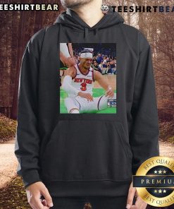 Josh Hart reacting after getting elbowed in the face, wearing a hoodie, showcasing a mix of surprise and determination.