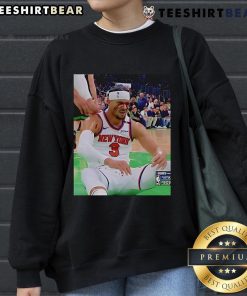 Josh Hart reacts after getting elbowed in the face, wearing a sweatshirt, capturing a dramatic moment in sports.