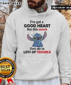 Alt Text: Person wearing 'I've Got A Good Heart But This Mouth Gets Me In Lots Of Trouble' hoodie, showcasing stylish streetwear.