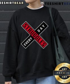 Cozy 'Top Struggles Every Day' sweatshirt displayed on a hanger, perfect for casual wear and expressing daily challenges.