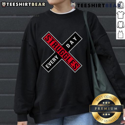 Cozy 'Top Struggles Every Day' sweatshirt displayed on a hanger, perfect for casual wear and expressing daily challenges.