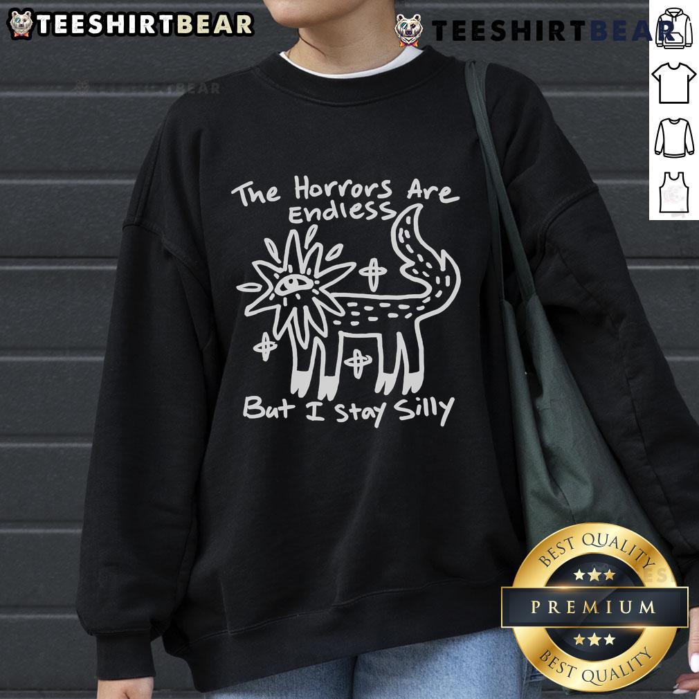 Top The Horrors Are Endless But I Stay Silly Sweatshirt Cozy Top The Horrors Are Endless But I Stay Silly sweatshirt featuring playful graphics and a comfortable fit.