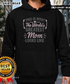 Mom wearing 'World's Greatest Mom' hoodie, smiling happily outdoors, showcasing love and pride for motherhood.