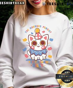 Cute cat in 'The Horrors Persist Yet I Remain' sweatshirt, showcasing a playful design perfect for cat lovers.