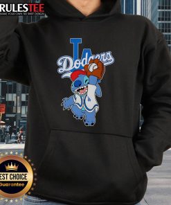Alt Text: Cute Stitch wearing a Los Angeles Dodgers hoodie while playing baseball in a vibrant outdoor setting.