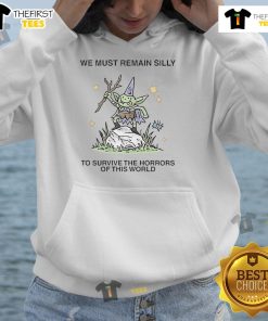 Cozy hoodie with 'We Must Remain Silly' slogan, perfect for staying cheerful amidst life's challenges. Cute and comfy design.