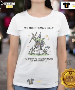 Cute ladies tee with 'We Must Remain Silly To Survive The Horrors Of This World' print, perfect for casual wear.