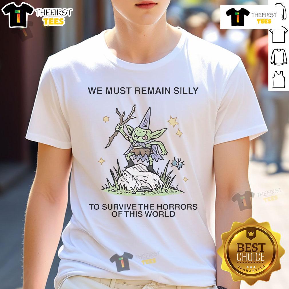 Cute We Must Remain Silly To Survive The Horrors Of This World T Shirt Alt Text: Cute We Must Remain Silly To Survive The Horrors Of This World T-Shirt design featuring playful typography and vibrant colors.