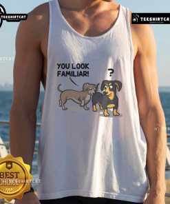 Funny dogs wearing 'You Look Familiar' tank tops, showcasing their playful personalities in a vibrant outdoor setting.