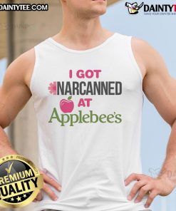 Person wearing a 'Good I Got Narcanned' tank top at an Apple restaurant, showcasing trendy casual style and humor.