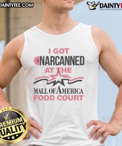 Person wearing a 'Good I Got Narcanned' tank top at a mall food court, showcasing trendy casual fashion.