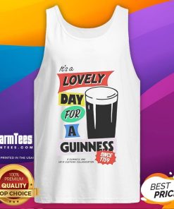 Person wearing a 'Good It's a Lovely Day for a Guinness' tank top outdoors, enjoying a sunny day.