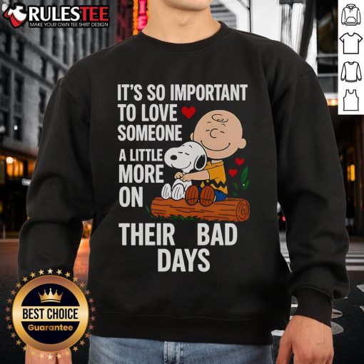 Alt Text: Good Snoopy sweatshirt with 'Love Someone More on Bad Days' text, featuring a cute Snoopy graphic.
