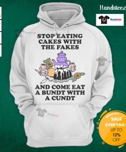 Person wearing 'Good Stop Eating Cakes With The Fakes' hoodie enjoying a Bundt cake, showcasing fun dessert culture.