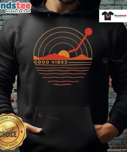Good Vibez Record sunset hoodie worn by a person against a vibrant sunset backdrop, showcasing relaxed streetwear style.