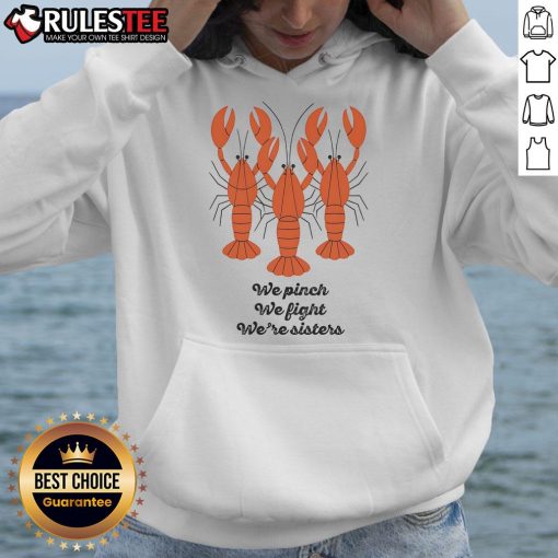 Alt Text: Sisters wearing 'Good We Pinch We Fight We're Sisters' lobster hoodie, smiling together in a casual setting.