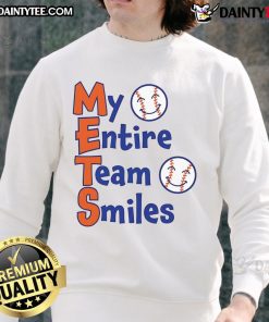 Happy Mets team members smiling in matching baseball sweatshirts, showcasing team spirit and camaraderie.