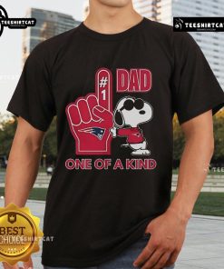Alt Text: Happy Snoopy wearing a New England Patriot Dad t-shirt, showcasing a unique design for sports fans and fathers.