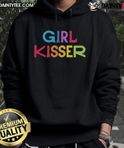Girl in a red hoodie with a kiss design, showcasing trendy street style in a vibrant urban setting.