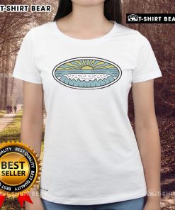 Women wearing Nice Sunny Shore Wituka Ladies Tee on a beach, enjoying the sun and waves in a vibrant summer setting.