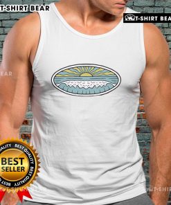 Model wearing a Nice Sunny Shore Wituka Tank Top on a beach, showcasing summer fashion and vibrant colors.