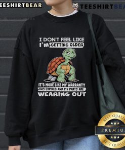 Alt Text: Cozy sweatshirt featuring a whimsical turtle design and the phrase I don't feel like I'm getting older, perfect for casual wear.