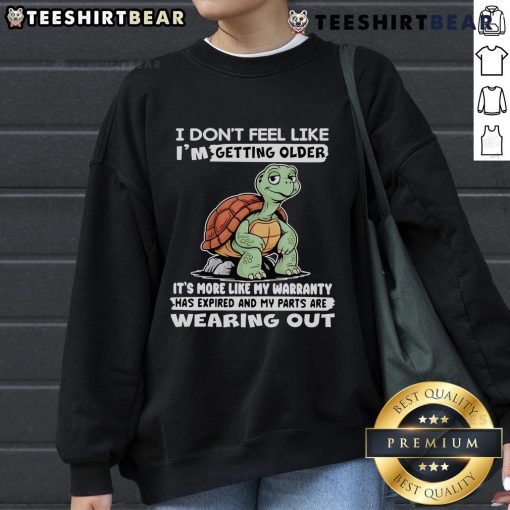 Alt Text: Cozy sweatshirt featuring a whimsical turtle design and the phrase I don't feel like I'm getting older, perfect for casual wear.