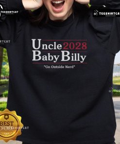 Alt Text: Baby Billy wearing a 'Go Outside Nerd' sweatshirt, smiling outdoors with his nice uncle, showcasing playful family moments.