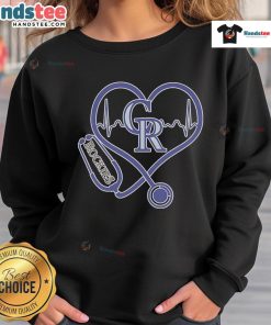 Alt Text: Official Colorado Rockies Caring Hearts Nurse sweatshirt featuring a stethoscope and heartbeat design.