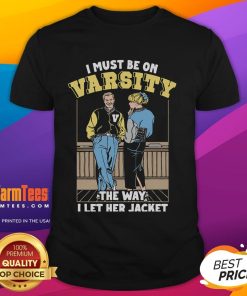 Alt Text: Official I Must Be On Varsity T-Shirt featuring stylish jacket design, perfect for sports fans and casual wear.