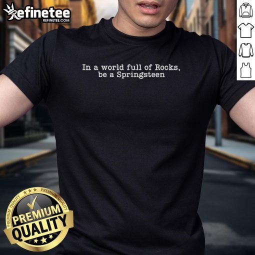 Official 'In A World Full Of Rocks Be A Springsteen' T-Shirt featuring bold text design in vibrant colors.
