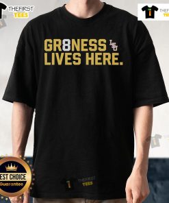 Alt Text: Official LSU Tigers Baseball National Champions Gr8Ness Lives Here logo T-shirt in purple and gold design.