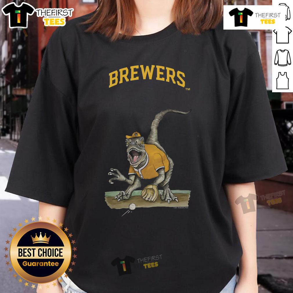 Official Milwaukee Brewers Tiny Turnip Velociraptor Ladies Tee Official Milwaukee Brewers Tiny Turnip Velociraptor Ladies Tee featuring a fun dinosaur graphic for fans.