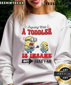 Minion arguing with a toddler in a playful scene, featuring the 'Official Minion Arguing With A Toddler Is Insane' sweatshirt.