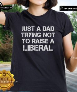 Official One Bad Dude Just A Dad Trying Not To Raise A Liberal Ladies Tee featuring a humorous dad-themed design.