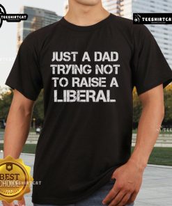 Official One Bad Dude T-Shirt for dads: 'Just A Dad Trying Not To Raise A Liberal' design in bold text.