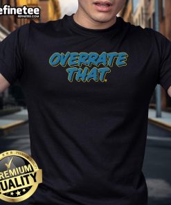 Official Pat McAfee wearing an 'Overrate That' t-shirt, showcasing his signature style and humor.