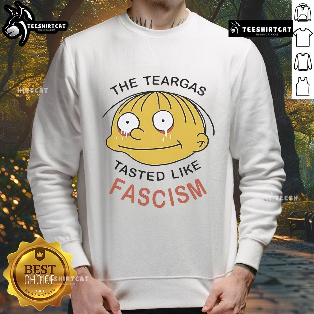 Official Ralph Wiggum The Teargas Tastes Like Fascism Sweatshirt Official Ralph Wiggum sweatshirt featuring 'The Teargas Tastes Like Fascism' design, perfect for fans of The Simpsons.